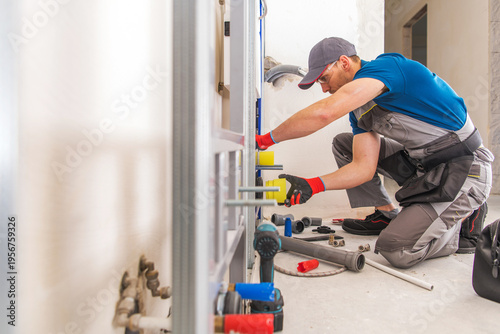 Plumber Works on Pipe Fittings in Indoor Space