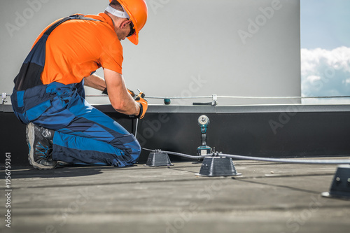 Konstfotografi Worker Installs Lightning Protection Equipment on a Rooftop in Daylight