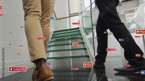 Two execs walking glass stairs, stepping onto treads and causing floating icons en route to meeting