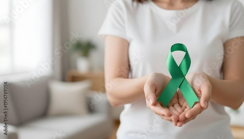 A woman displays a green awareness ribbon, representing Celiac Disease awareness and the importance of gluten-free diets
