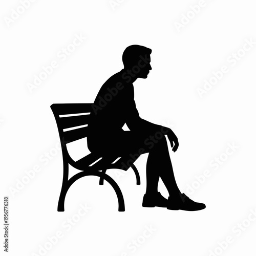 Man sitting on a chair in silhouette.