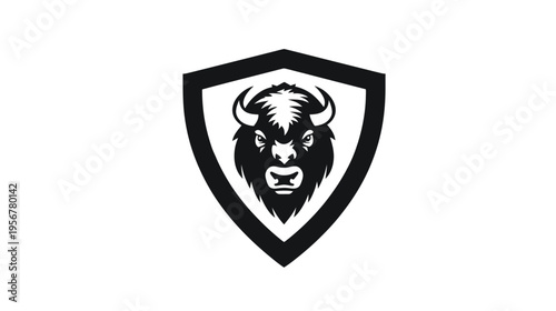 A monochrome illustration of a bison head within a shield shape. The bison has horns and a stern face