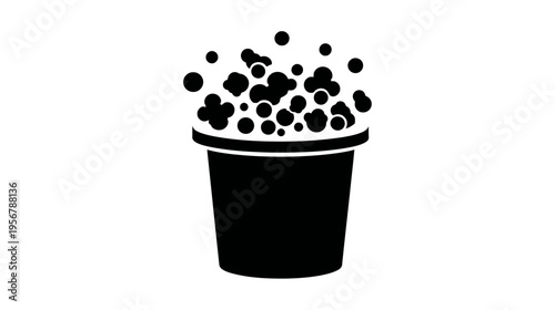 A black and white illustration of a bucket overflowing with circular objects, placed centrally