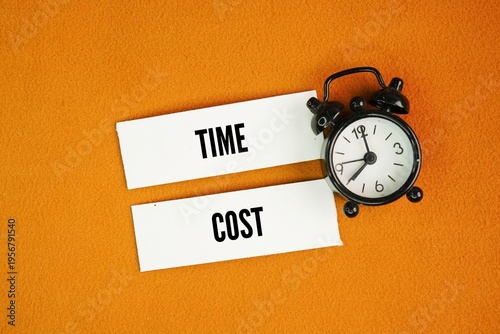 Fotografie A bell clock with two words Time and cost are critical, interconnected component