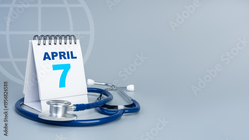 World Health Day banner concept. April 7 desk calendar with stethoscope and global symbol on blue background. Healthcare awareness, medical campaign, wellness and hospital services theme.