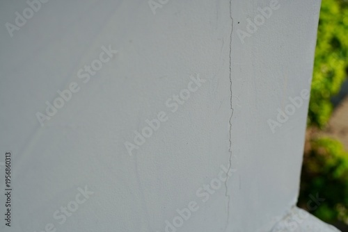 A long crack on a light-colored plaster wall, indicating structural wear and aging.