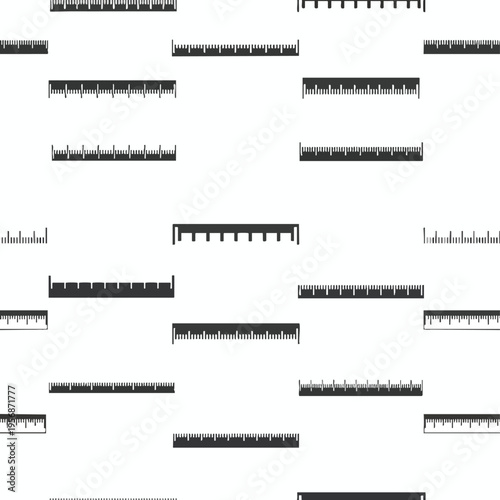 Multiple rulers with precision markings scattered across a white background