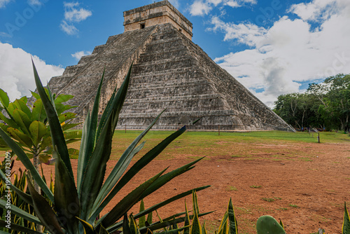 Schilderij op canvas Ancient Mayan pyramid rises under blue sky