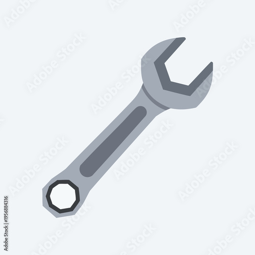 A silver open-ended wrench lies diagonally on a plain, light blue background