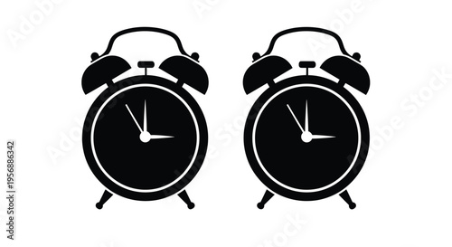 Two black silhouette alarm clocks displaying slightly different times