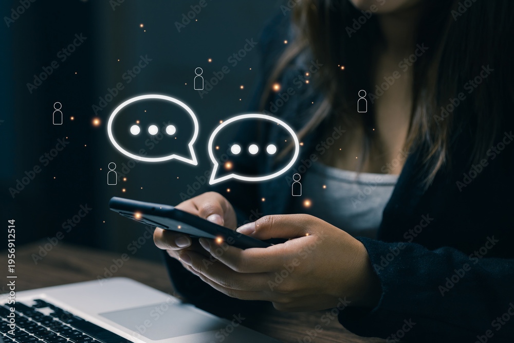 © saranyoo - Social communication concept with woman using smartphone and chat bubbles, representing messaging app, online conversation, social media interaction, digital lifestyle and mobile communication.