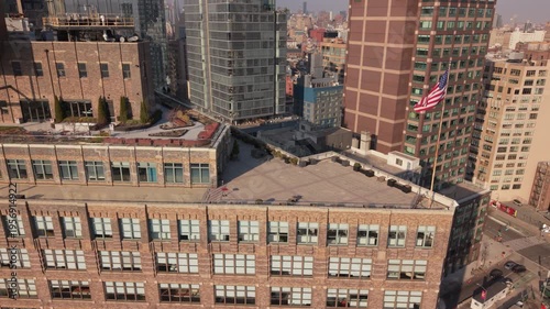 flying counter clockwise around American flag at corner of Canal and 6th Ave. in NYC