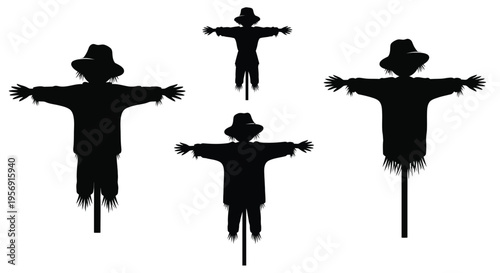 Four scarecrows stand in a field a striking black silhouette