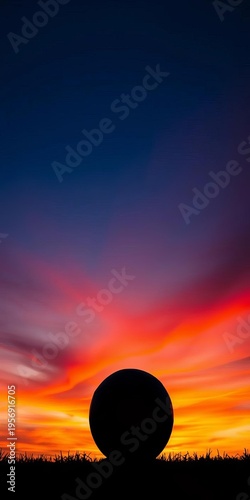 Soccer ball silhouette against a vibrant sunset sky, evoking passion and the joy of the game,  hour,  joy