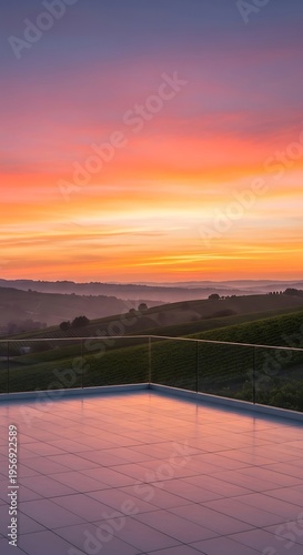 Breathtaking Tuscan sunset over rolling hills and vineyards from a modern balcony with glass railing and reflective floor