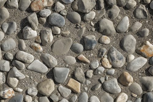 An aerial view of a large, stony surface ground texture. Image is ready to be tiled to create a much larger image or higher resolution background of a detailed sandy pebble aggregate floor