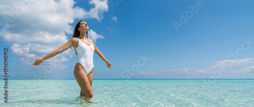 Authentic woman enjoys crystal clear ocean waters with bright sunny skies