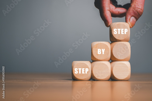 Hand placing wooden blocks with 
