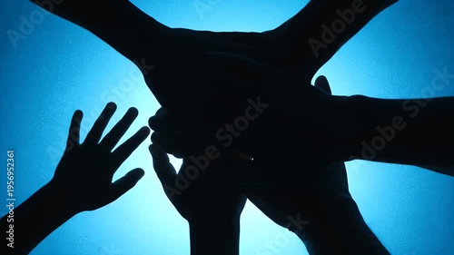 Wallpaper Mural Silhouetted hands overlap against a luminous blue background, forming a shared focal point Torontodigital.ca