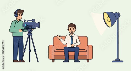 Filming interview with businessman on sofa, cameraman recording, studio lighting setup