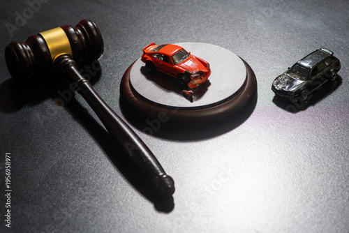 Gavel in traffic court for law and enforcement. Car accident in traffic court for speeding and injury. Gavel for regulation and penalty in traffic court. Car for insurance claim and liability.