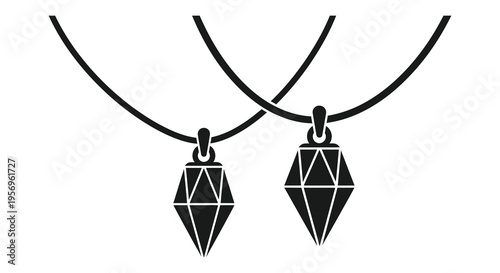 Two geometric pendants hanging from cords a striking silhouette