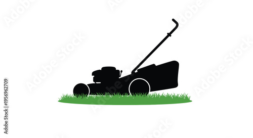 Black lawnmower on green grass a striking visual silhouette