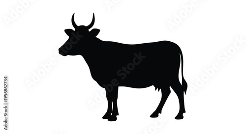 Black silhouette of a cow standing in a field silhouette