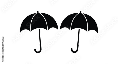 Two black umbrellas displayed against a white background a stark silhouette