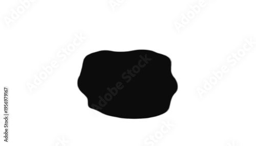 Abstract black ink blot shape stains the pure white background with an organic, irregular form.