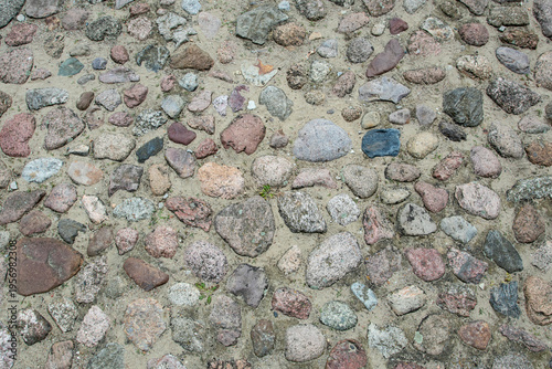 Variety of stones arranged on ground in different colors and shapes at a natural setting during daytime