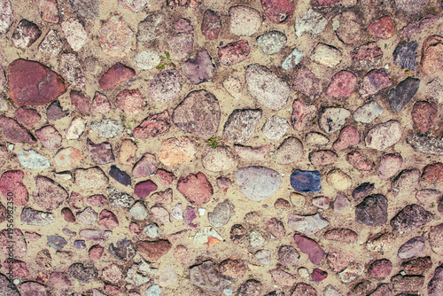 Variety of stones arranged on ground in different colors and shapes at a natural setting during daytime