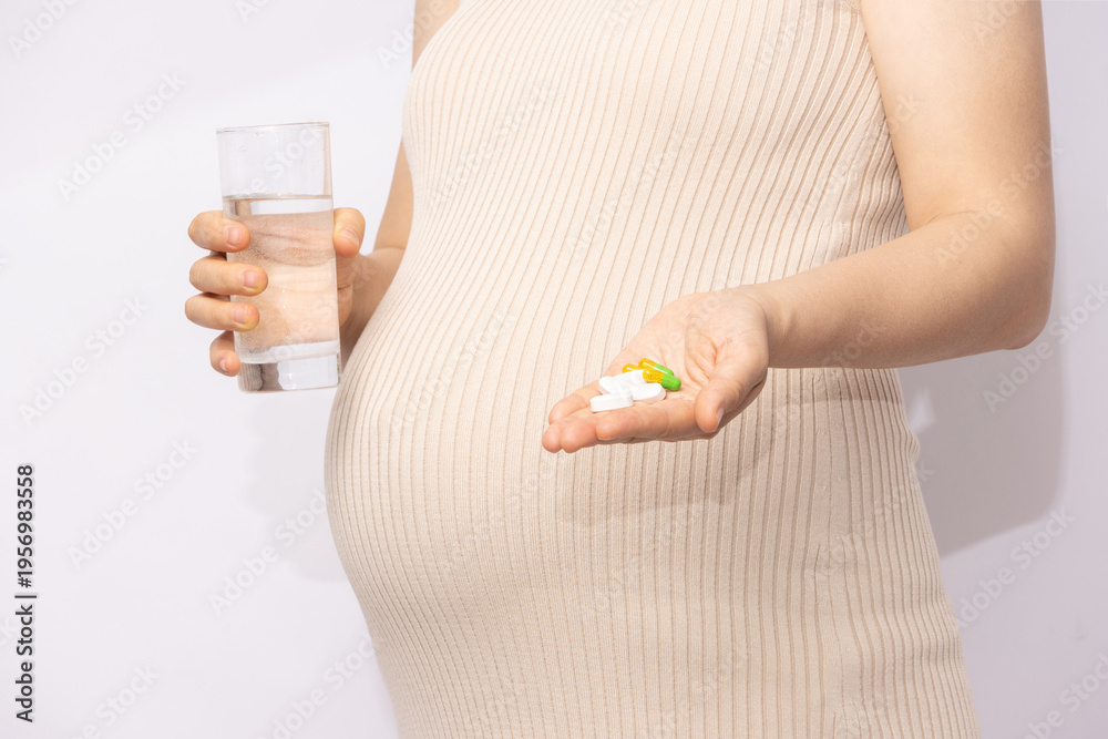 Obraz premium Pregnant Woman Taking Medication