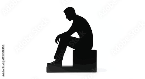 A seated man in a dark silhouette contemplates appearing somber and alone silhouette