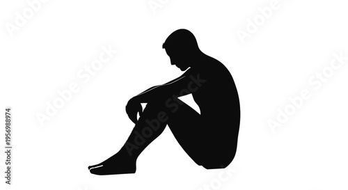 A solitary figure sits with head in hands expressing sadness silhouette