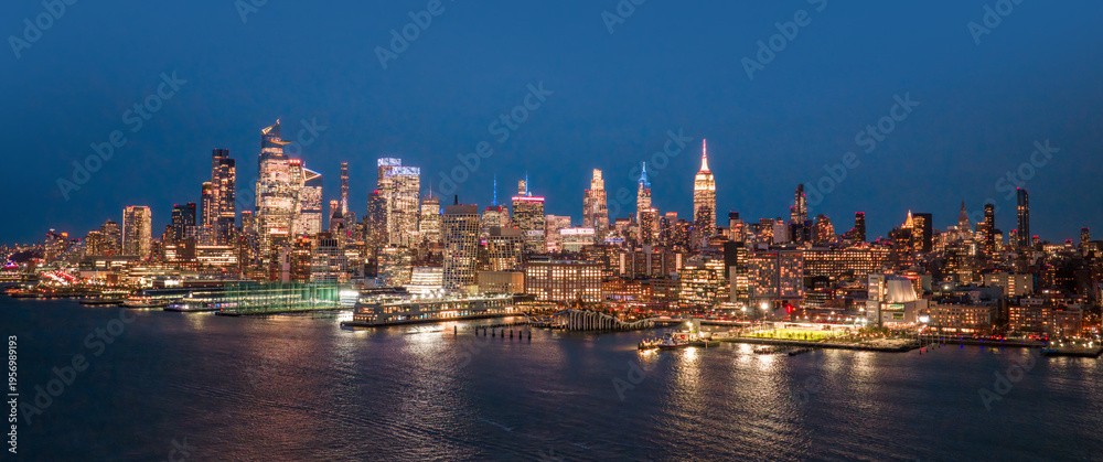 Fototapeta premium NYC cityscape. New York waterfront. New York aerial view of Manhattan skyscrapers. New York City skyscrapers panoramic landscape. NYC panoramic view of Lower Manhattan skyline. New York City at night.