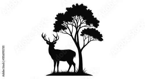 Majestic stag stands beneath trees in a striking black silhouette