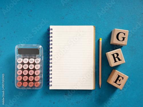 Preparing for GRE exam with calculator, notebook and pencil