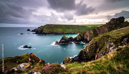 Dramatic Coastal Landscape with Rugged Cliffs and Turquoise Sea Under Moody Sky.