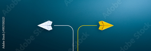 Two paper planes flying in opposite directions on blue background, concept of decision making and choosing different paths.