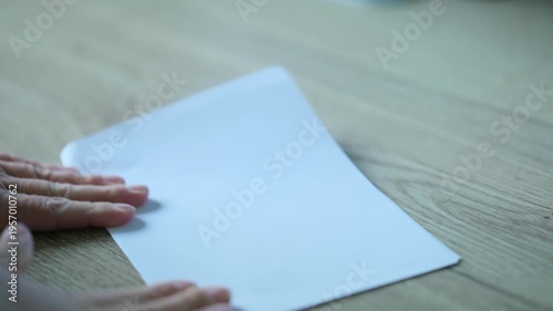 I fold the white paper in half.