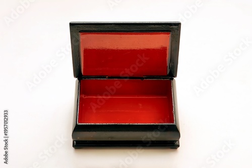Open, rectangular black box with a striking red interior, placed against a white background, showcasing simplicity and elegance.