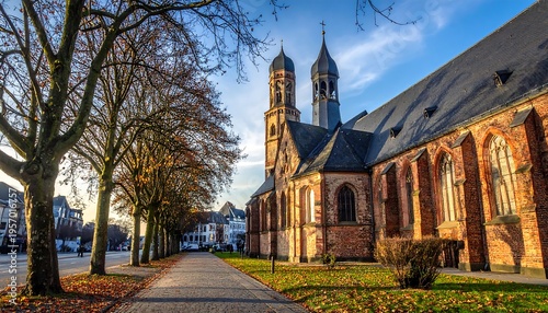 Historic Church Facade with Autumn Trees and Pathway.