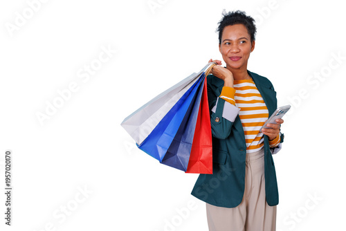 Stylish african american woman holding shopping bags and smartphone on transparent background representing modern retail
