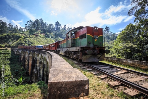 Iconic Train Crossing the Nine Arch Bridge Amidst Lush Sri Lankan Hill Country