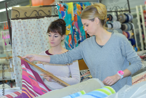 Photos two women shopping together in fabric shop