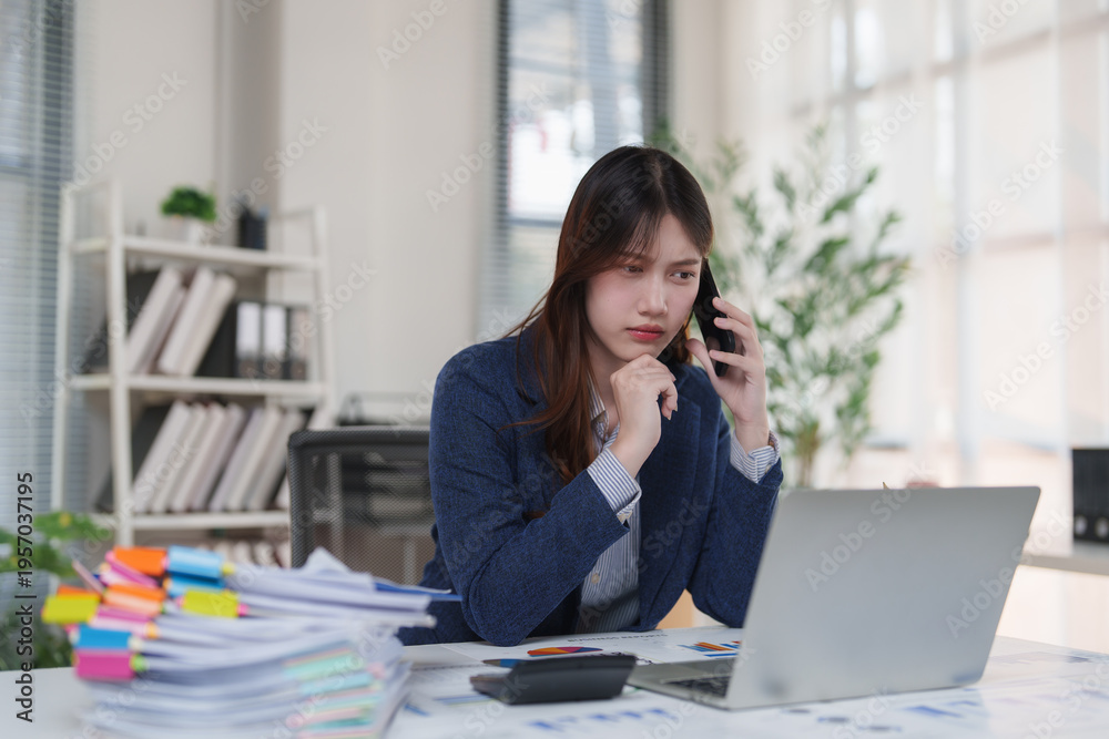 Fototapeta premium Young businesswoman discussing serious matter on phone