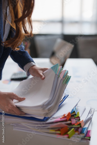 Employee organizing stack of business documents and files
