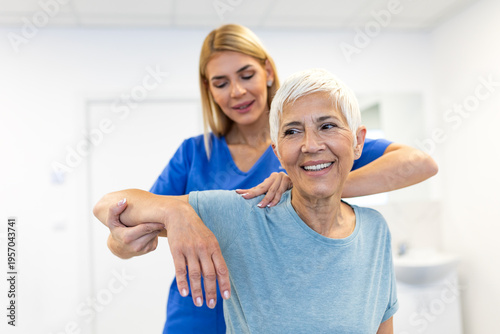 Photography Physiotherapist helping senior woman with shoulder rehabilitation exercises