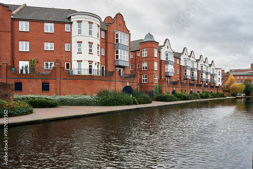 Modern red brick apartment buildings and residential flats along the Worcester and Birmingham Canal, Gas Street Basin, Birmingham, West Midlands, England, UK.
